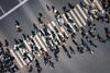 a birds' eye view of a crowd of people walking across a zebra crossing 